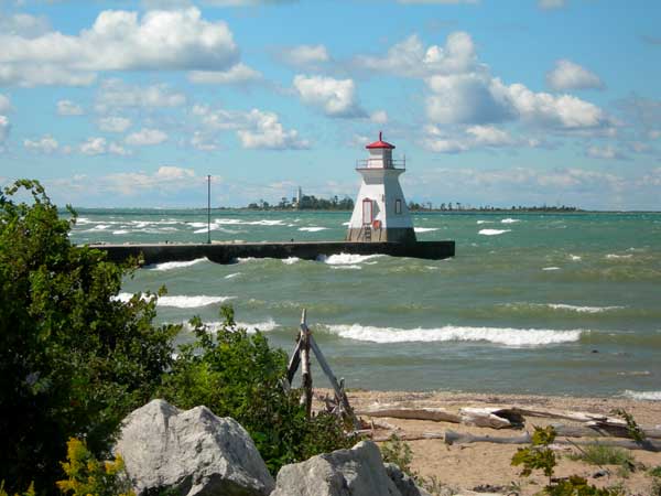 Waves roll in around the white and red light